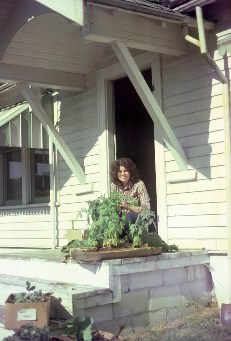 Anita on porch with tomato plants