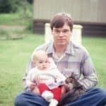 Brian in the yard with Carrie and a cat