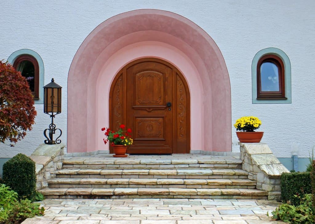 Front door with flowers nearby